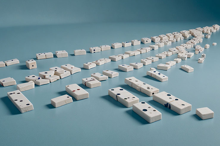  A line of dominos falling in sequence, symbolizing the chain reaction of thoughts